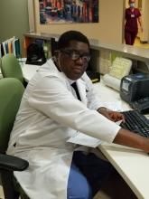 Dr. Keji Fagbemi works at his desk at BronxCare Health System's inpatient detoxification unit.