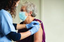 Giving COVID-19 vaccine to senior woman