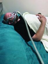 A man uses a CPAP device