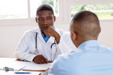 A doctor listens to a patient