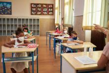 Children wearing protective face masks in a classrom during the COVID-19 pandemic