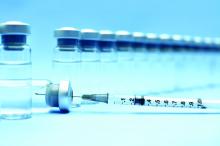 Closeup of vaccines and a needle