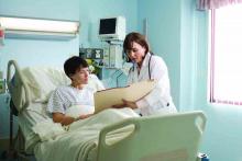 Doctor and patient in hospital bed