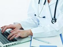 A doctor enters information into an electronic health record.