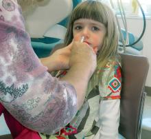 A child receives H1N1 flu mist.