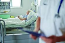 A patient rests in a hospital bed.