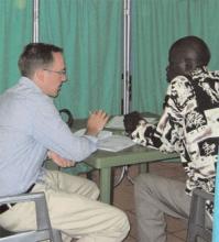 Dr. Hamerski chats with a patient at a clinic in Uganda.