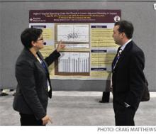 Tara Lagu, MD, MPH, (left) explains her RIV poster to Evan Fieldston, MD.