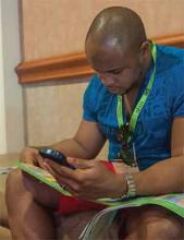 Uzoeshi Anukam, MD, from Grand Prairie, Texas, looks over the HM14 schedule at Mandalay Bay Resort and Casino in Las Vegas, Nev.