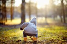 A toddler plays outside.